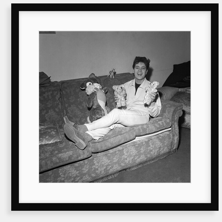 Cliff Richard on a sofa with soft toys by Harry Hammond