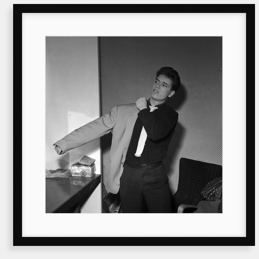 Cliff Richard putting his jacket on by Harry Hammond