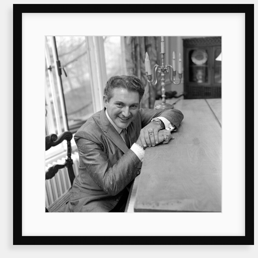 Liberace seated at the piano at the Savoy Hotel by Harry Hammond