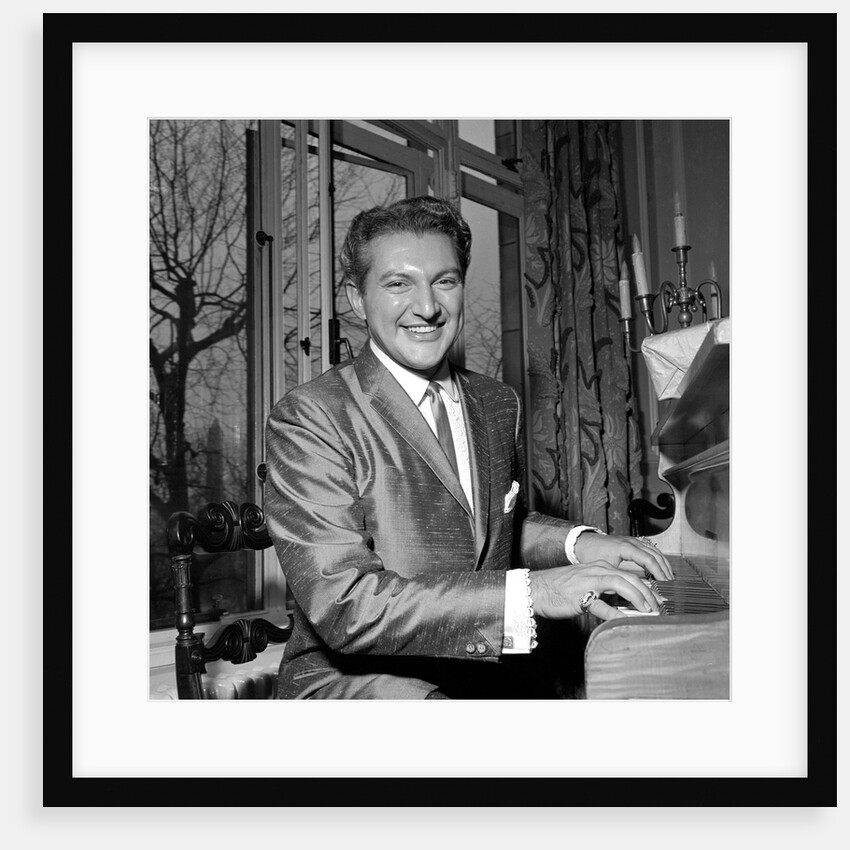Liberace playing the piano at the Savoy Hotel by Harry Hammond