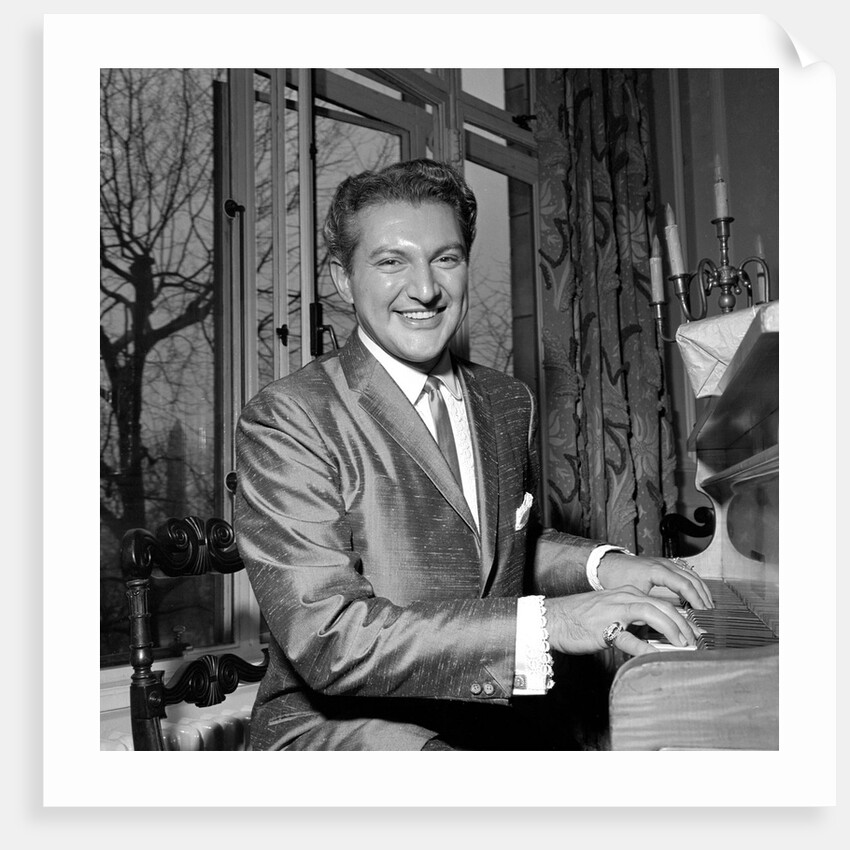 Liberace playing the piano at the Savoy Hotel by Harry Hammond