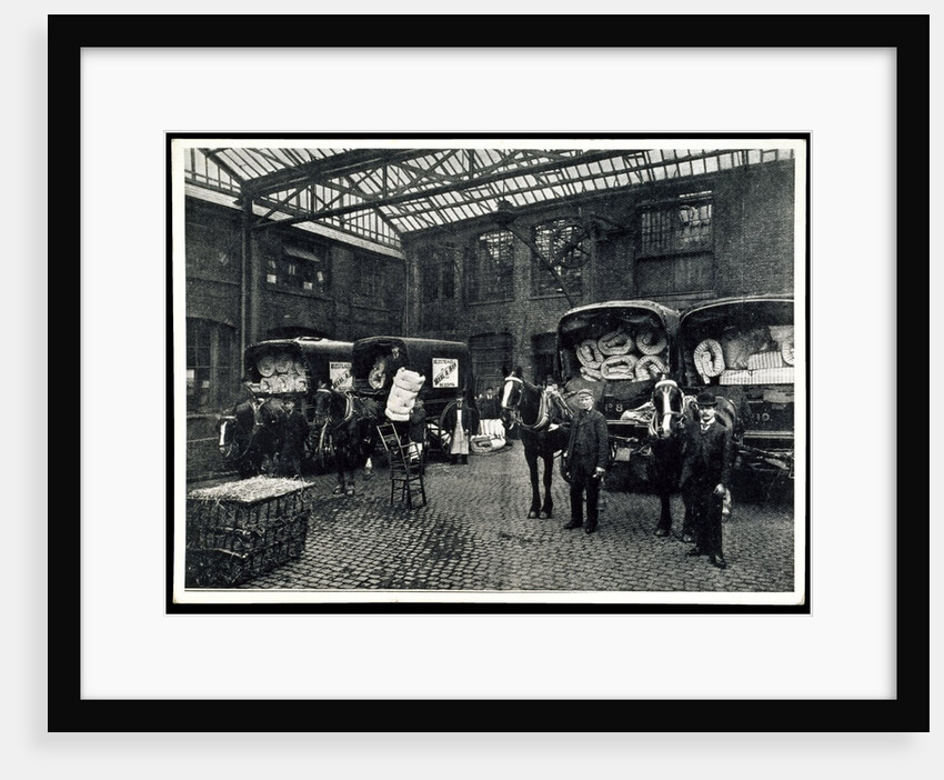 Loading up new matresses for delivery in the yard of Torrington Place by Unknown