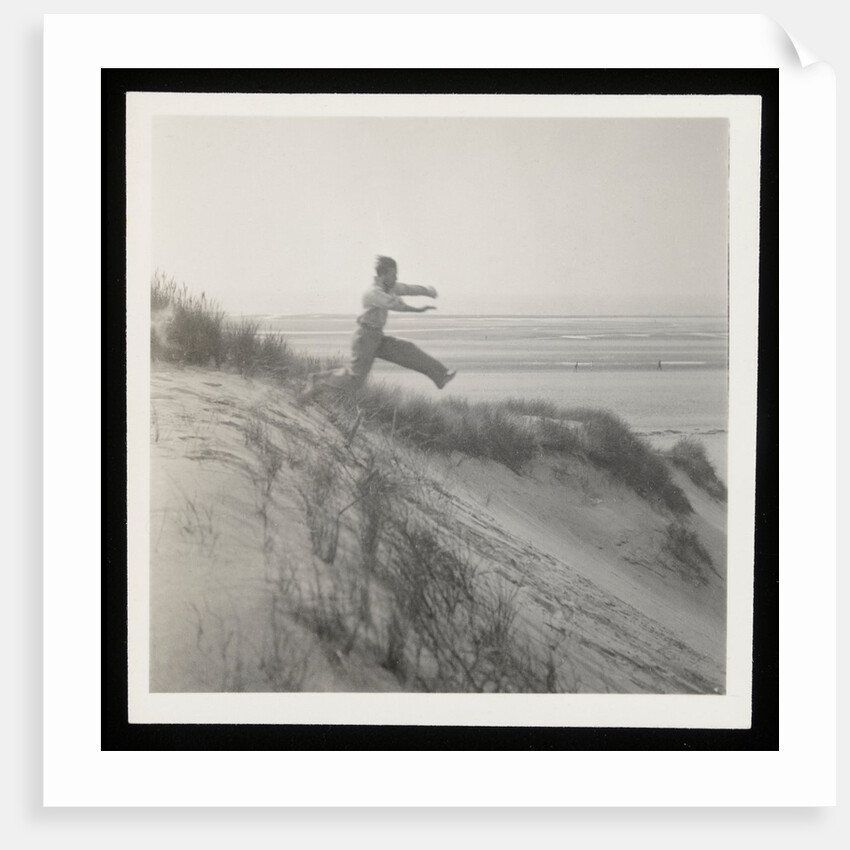 Man jumping off sand dune by Curtis Moffat