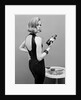 Model holding bottle of poison by John French