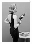 Model holding bottle of poison by John French