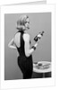 Model holding bottle of poison by John French