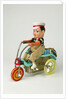 Clockwork toy boy on a tricycle by Unknown