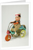 Clockwork toy boy on a tricycle by Unknown