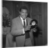 Chubby Checker holding a record by Harry Hammond