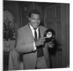 Chubby Checker holding a record by Harry Hammond