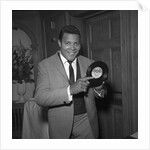 Chubby Checker holding a record by Harry Hammond