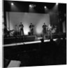 Johnny Hallyday with band performing on the Palladium Stage by Harry Hammond
