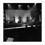 Johnny Hallyday with band performing on the Palladium Stage by Harry Hammond