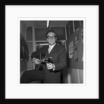 Peter Sellers holding a guitar by Harry Hammond