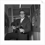 Peter Sellers holding a guitar by Harry Hammond