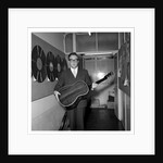 Peter Sellers holding a guitar by Harry Hammond