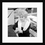 Marion Ryan, 1950s British pop singer, seated by a piano by Harry Hammond