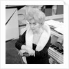 Marion Ryan, 1950s British pop singer, seated by a piano by Harry Hammond