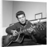 Cliff Richard playing his guitar by Harry Hammond