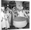 Cliff Richard mixing a giant Christmas pudding at J.Lyons in Cadby Hall, Hammersmith by Harry Hammond