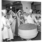 Cliff Richard mixing a giant Christmas pudding at J.Lyons in Cadby Hall, Hammersmith by Harry Hammond