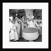Cliff Richard mixing a giant Christmas pudding at J.Lyons in Cadby Hall, Hammersmith by Harry Hammond