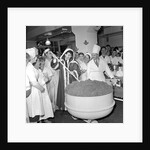 Cliff Richard mixing a giant Christmas pudding at J.Lyons in Cadby Hall, Hammersmith by Harry Hammond