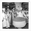 Cliff Richard mixing a giant Christmas pudding at J.Lyons in Cadby Hall, Hammersmith by Harry Hammond