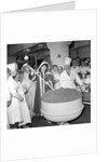 Cliff Richard mixing a giant Christmas pudding at J.Lyons in Cadby Hall, Hammersmith by Harry Hammond