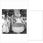 Cliff Richard mixing a giant Christmas pudding at J.Lyons in Cadby Hall, Hammersmith by Harry Hammond