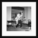 Cliff Richard playing the guitar by Harry Hammond
