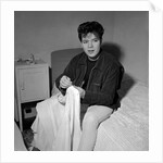Cliff Richard in his first house sitting on a bed by Harry Hammond