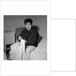 Cliff Richard in his first house sitting on a bed by Harry Hammond