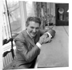 Liberace seated at the piano at the Savoy Hotel by Harry Hammond