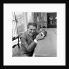 Liberace seated at the piano at the Savoy Hotel by Harry Hammond