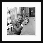 Liberace seated at the piano at the Savoy Hotel by Harry Hammond