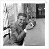 Liberace seated at the piano at the Savoy Hotel by Harry Hammond
