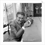 Liberace seated at the piano at the Savoy Hotel by Harry Hammond