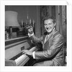 Liberace playing the piano at the Savoy Hotel by Harry Hammond