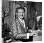 Liberace playing the piano at the Savoy Hotel by Harry Hammond