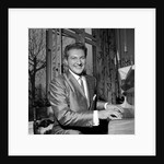 Liberace playing the piano at the Savoy Hotel by Harry Hammond