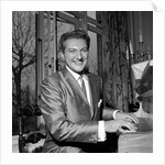 Liberace playing the piano at the Savoy Hotel by Harry Hammond