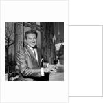 Liberace playing the piano at the Savoy Hotel by Harry Hammond