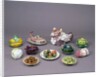 Arrangement of ceramic tureens and trick plates in the shape of vegetables and other food by Unknown
