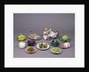 Arrangement of ceramic tureens and trick plates in the shape of vegetables and other food by Unknown