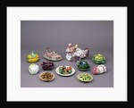 Arrangement of ceramic tureens and trick plates in the shape of vegetables and other food by Unknown