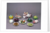 Arrangement of ceramic tureens and trick plates in the shape of vegetables and other food by Unknown