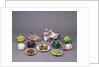Arrangement of ceramic tureens and trick plates in the shape of vegetables and other food by Unknown