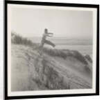 Man jumping off sand dune by Curtis Moffat